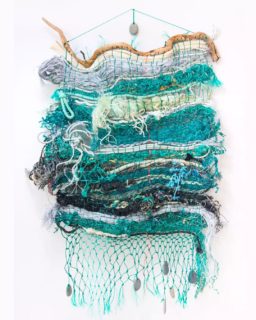 2020 / 2022
Sea Stories weaving
6ft x 40" x 8"

Created in public during Ghost Net Landscape "Sea Stories" exhibit in fall 2020. Sea Stories was my last major project before my grandparents died of Covid and I suddenly couldn't be the same person. I used to be organized, reliable, and methodical. In a deeper sense, my self worth was centered on how helpful I could be towards others, how comfortable I could make them feel. A lot of my energy goes into releasing the guilt of not being that person any more, and learning how to be who I am now.

I'm starting to revisit some of the fragments of these past two years. This week I finished up the fringe and added the crown stone to call this weaving done. It feels good to have this beautiful piece on display in my home. Not for sale.

Made with reclaimed fishing gear from @surfriderkauai and @westport_marina
Warp strung by @shelbysilver.ecologicalart
Last photo by Shino Yanagawa at @cremapdx during @portlandtextilemonth 
.
.
.
#oceaninspired #recycledart #fiberart #reclaimedmaterials #ghostnetart #ghostnet #hawaiiart #fishingrope #fishingnet #contemporarysculpture #socialpractice #collaboration #artplay #pdxartist #portlandartist #oregonartist #ghostnetlandscape #weaving #oceanplastic #oceantrash #plasticocean